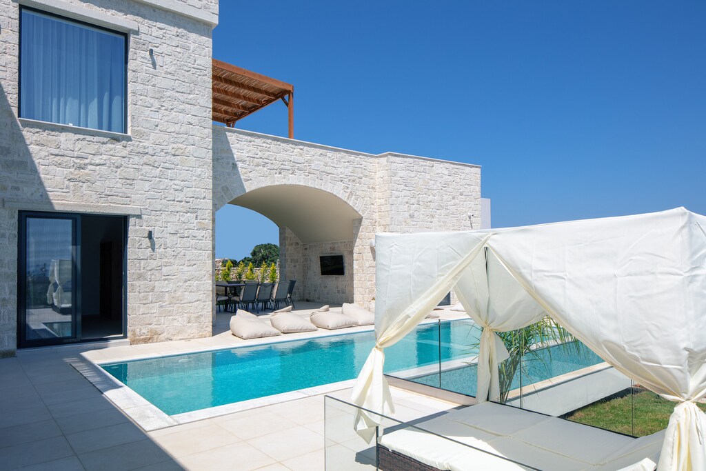 The stone archway welcomes guests to this luxury self-catering home in Crete