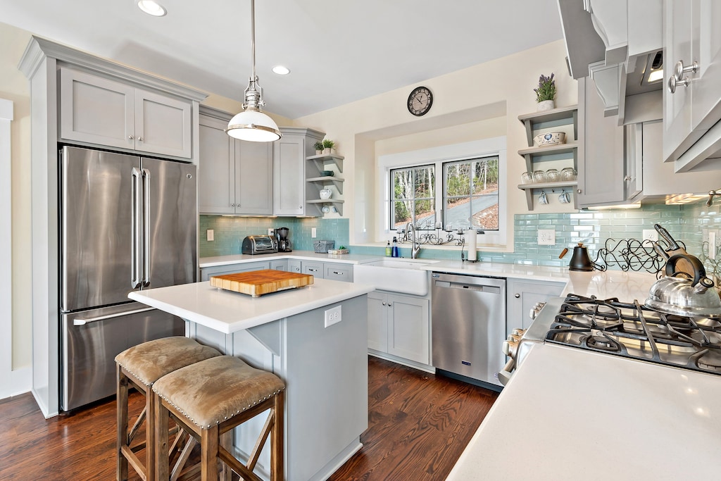 The chef-inspired kitchen features high-end stainless steel appliances, granite countertops, and a spacious island, making meal preparation a delight.