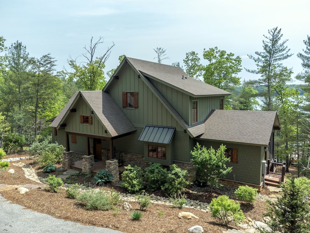 This beautifully designed home boasts a private dock and expansive decks, providing unparalleled access to the serene waters of Lake James.