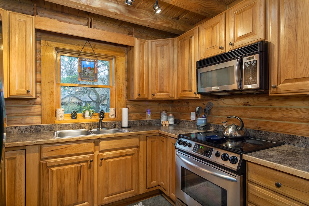 Kitchen with dishwasher, coffee grinder, and two types of coffeemakers (Keurig & standard drip).