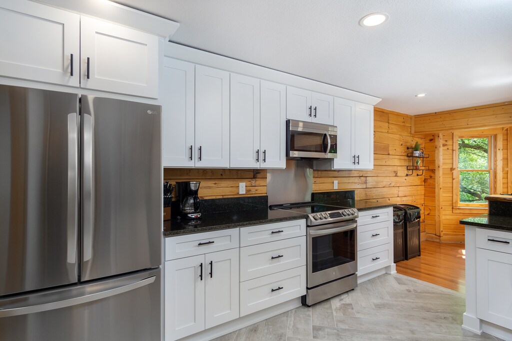 Well-equipped kitchen with drip-style coffee pot, dishwasher, and stainless appliances
