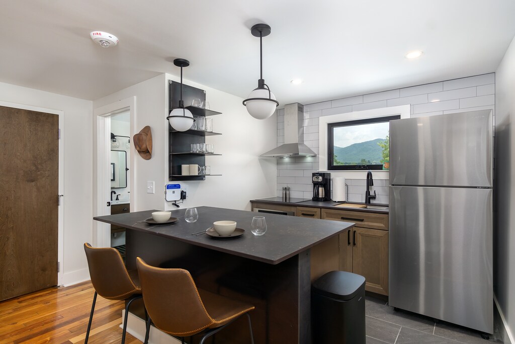 Open-concept kitchen with stainless appliances and breakfast bar seating for 2. Please note: The standard drip-style coffeemaker has been replaced with a Keurig.