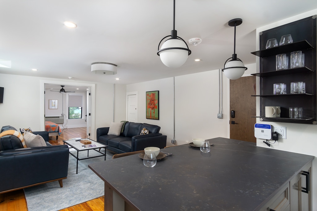 Open-concept kitchen with stainless appliances, standard, drip-style coffee maker, and breakfast bar seating for 2.