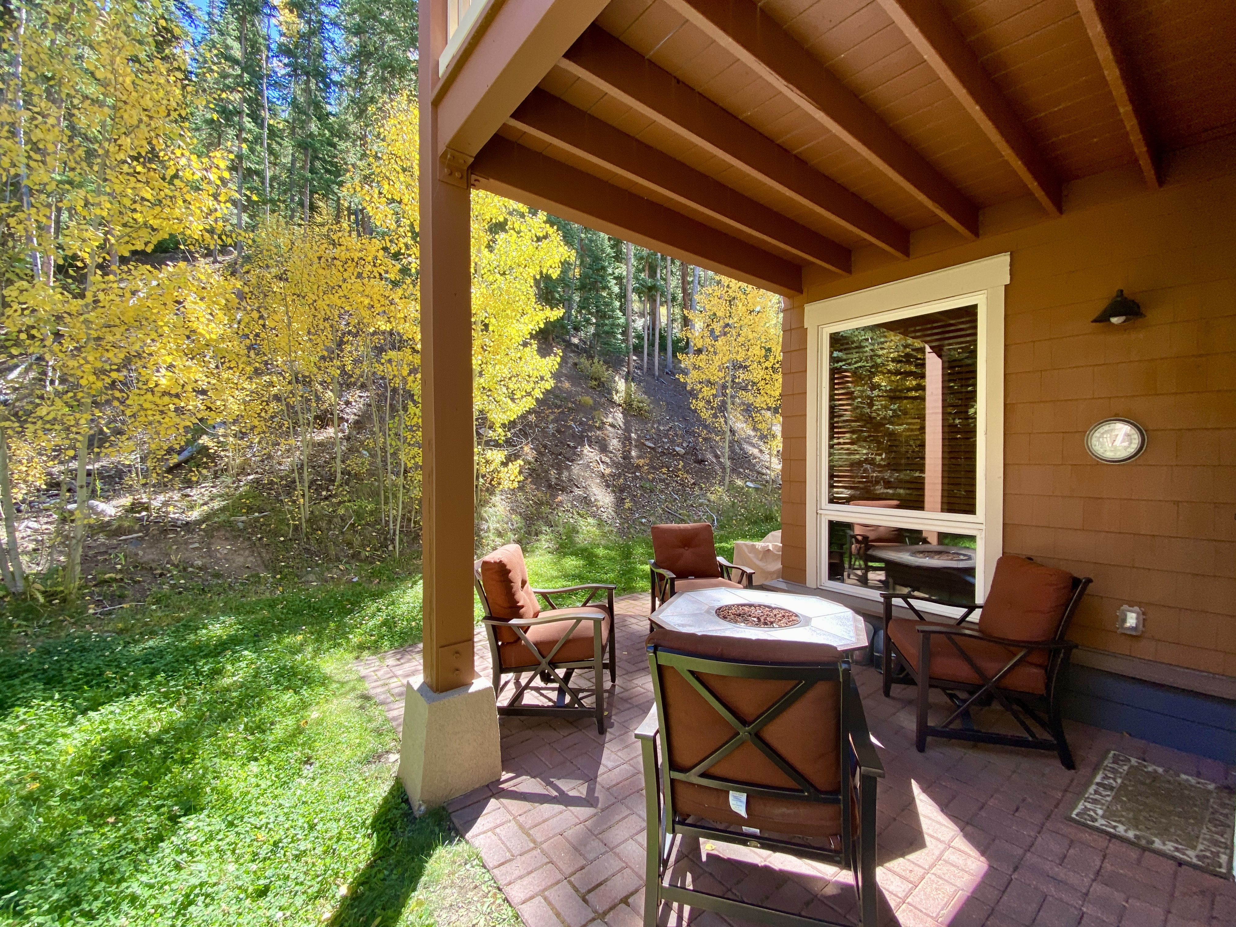 Comfortable back patio with a fire pit!