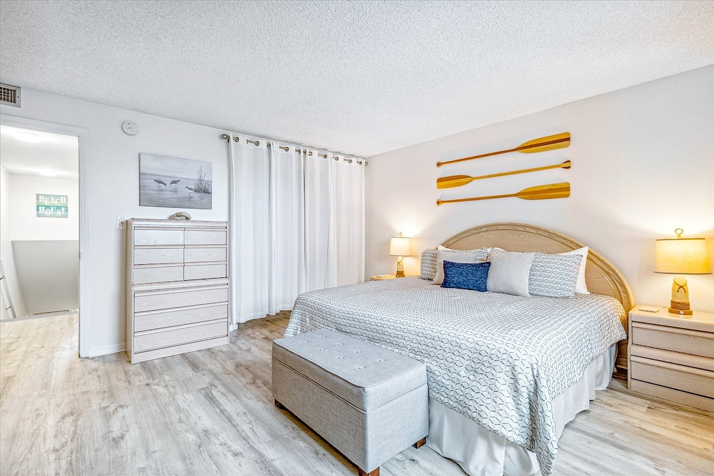 Elegant upstairs master bedroom featuring a cozy king bed for a peaceful night's sleep.