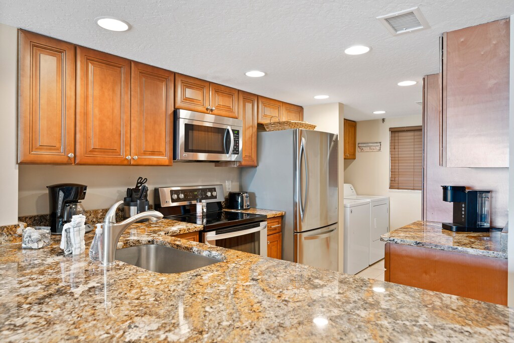 Step into a fully equipped kitchen with beautiful view.
