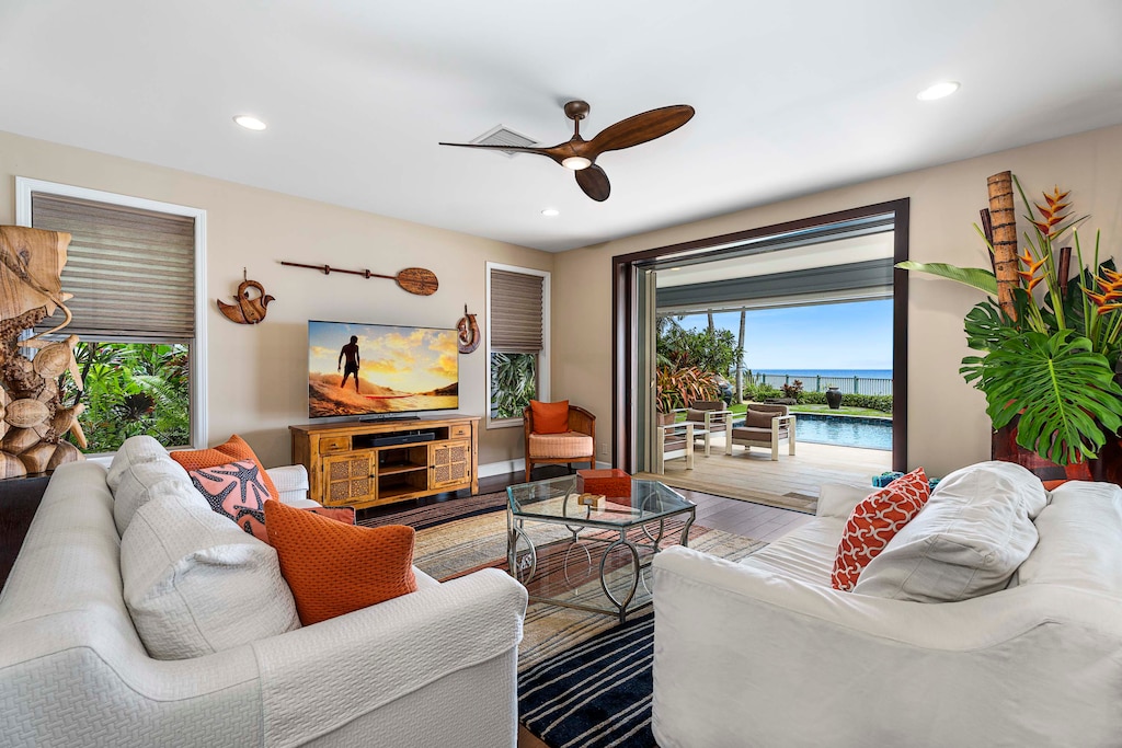 Open living room with sliding doors that extend the space to the pool and ocean.
