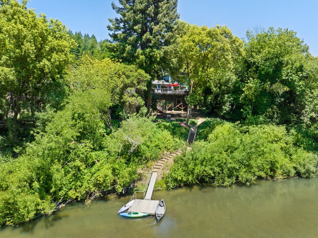 Moondance on the Russian River with seasonal boats and dock.