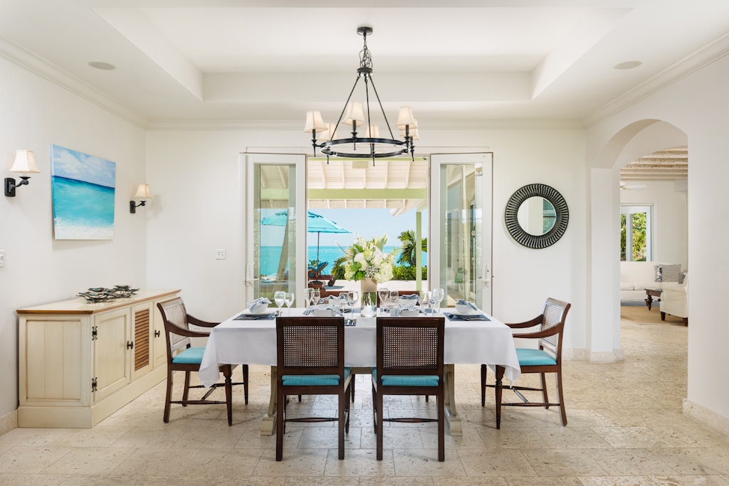 Alongside the kitchen is the dining table, with poolside views