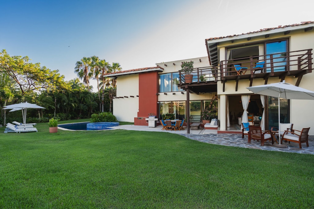 The yard is open and spacious, perfect for playing catch.