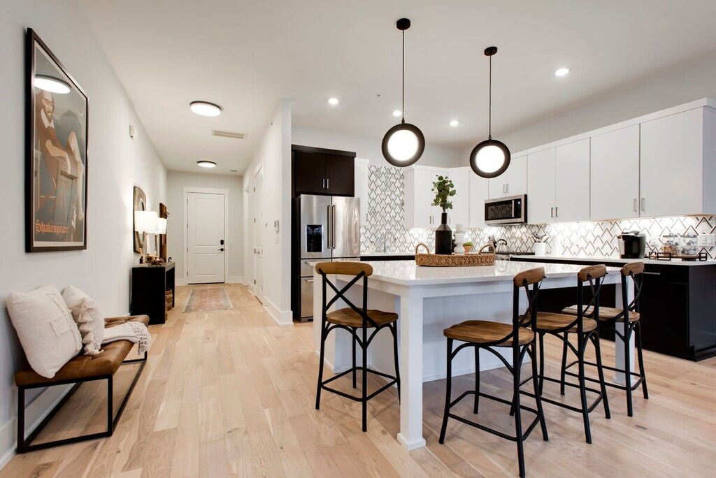 High ceilings and streams of natural light welcome you, making every space feel open and inviting!