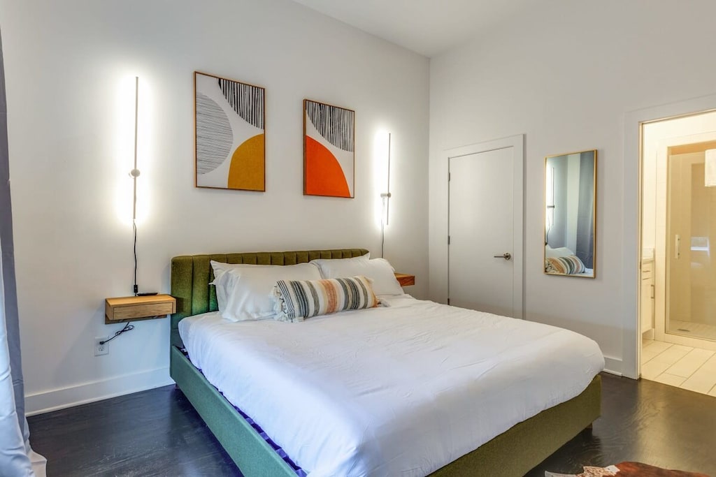 On the first floor, we have a large king suite with large windows, a smart TV and an attached bathroom.