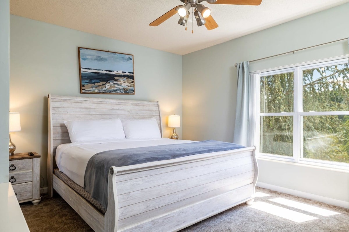 Unwind in our roomy and sunlit primary bedroom, offering a snug and inviting ambiance.
