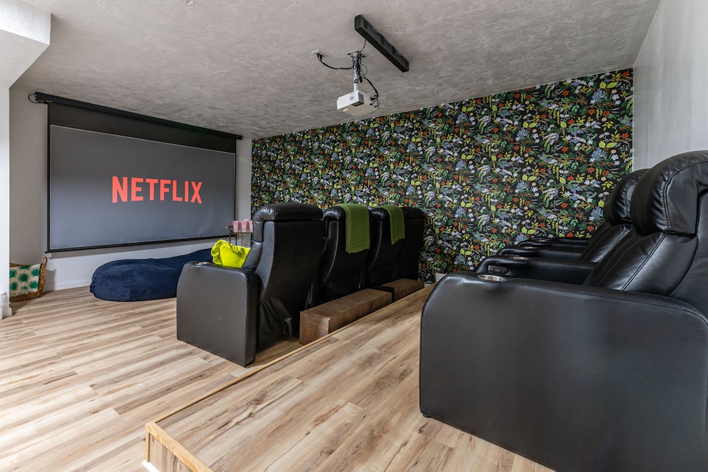 Indulge in movie magic with our theatre room featuring a projector and deluxe reclining seating