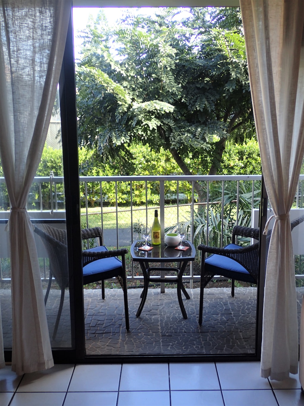 Lanai surrounded by lush tropical foliage