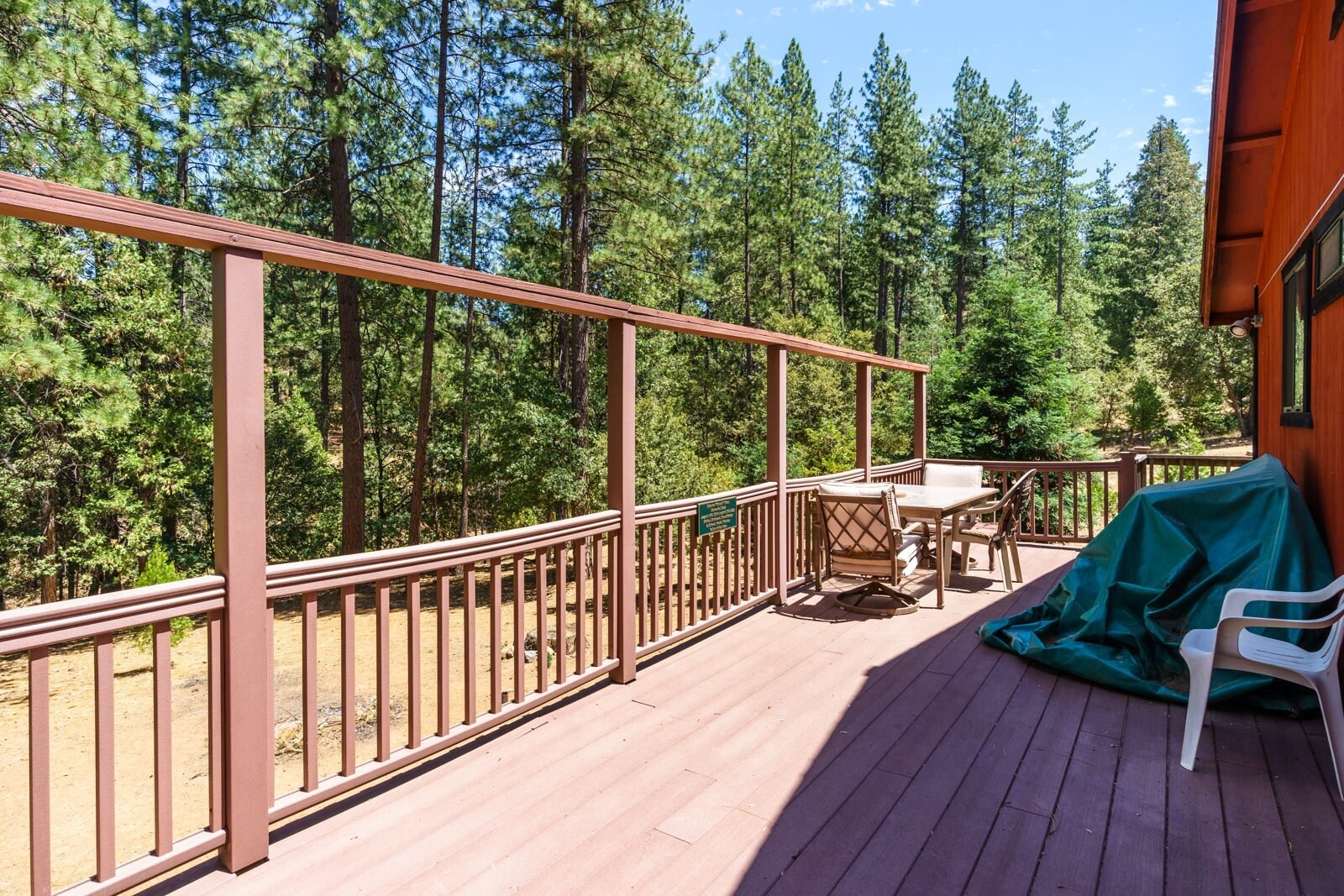 Back deck with table & chairs. Unit 8 Lot 9, The Hideout, Pine Mountain Lake Vacation Rental.