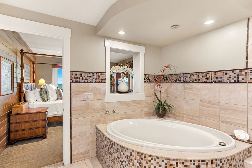 A marble bathroom provides a deep soaking tub.