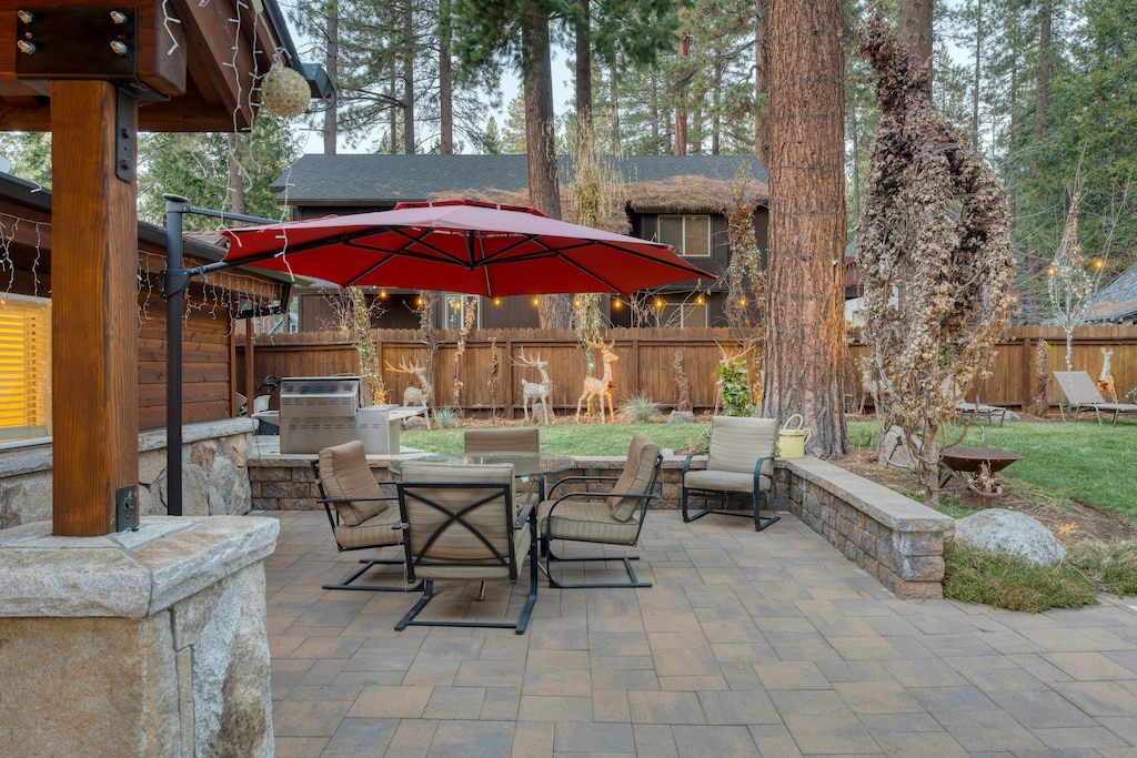 Large patio with al fresco dining area and a BBQ grill.