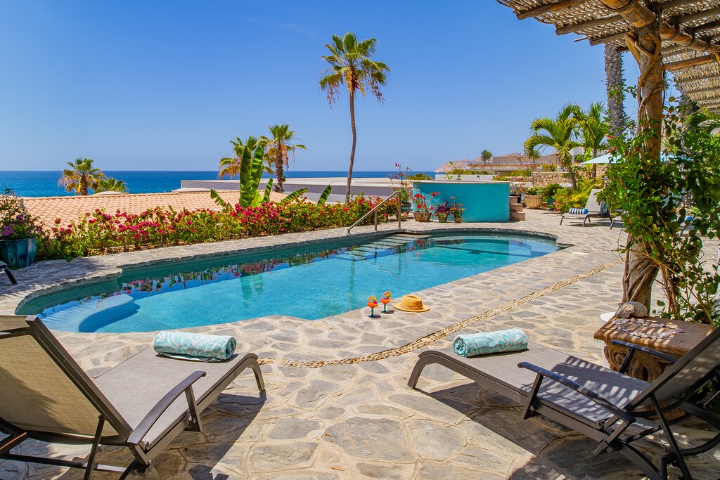 Sunny poolside patio with ocean views