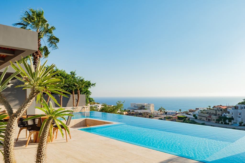 Sunny patio with infinity pool and ocean view