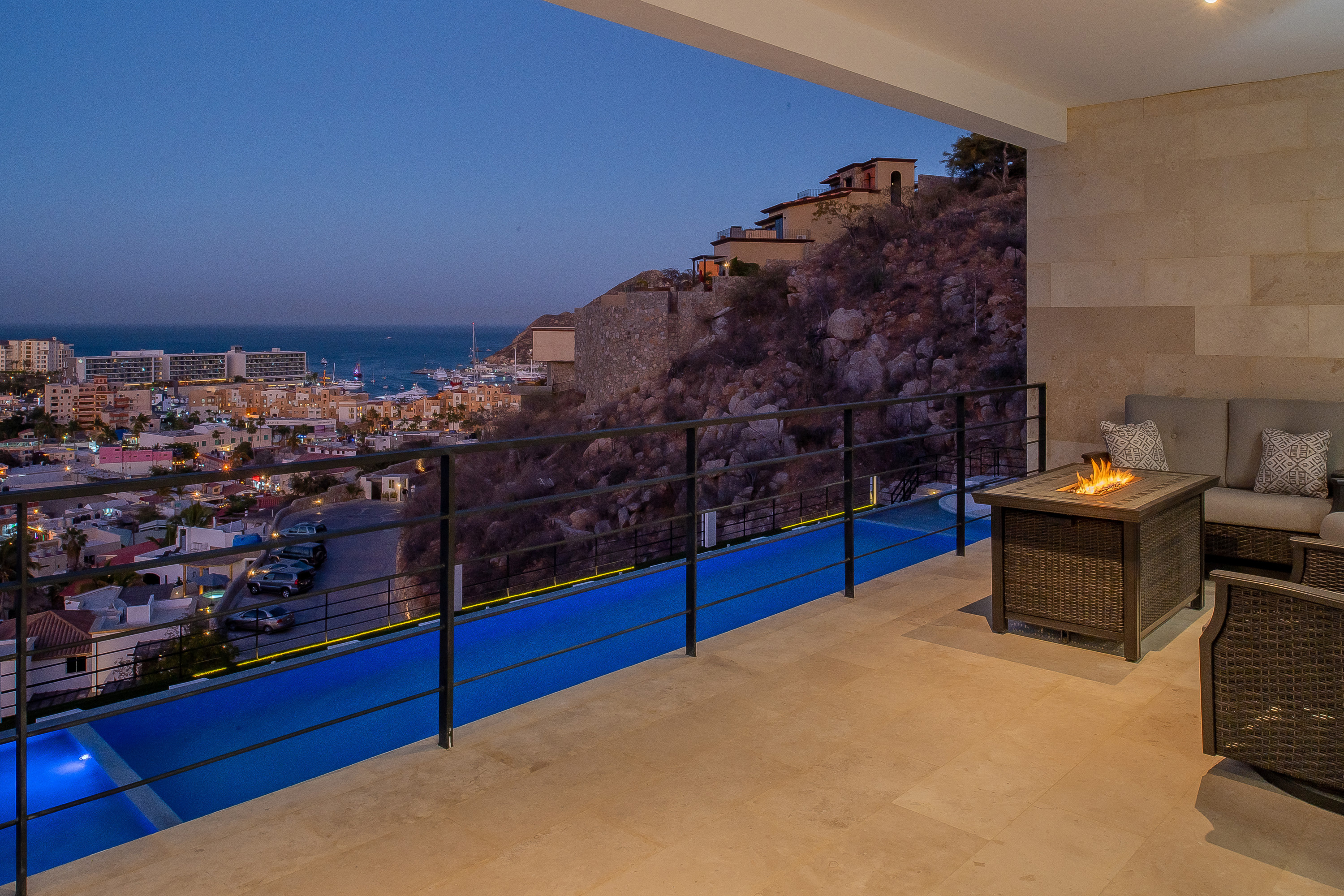 Terrace with city and ocean view at night