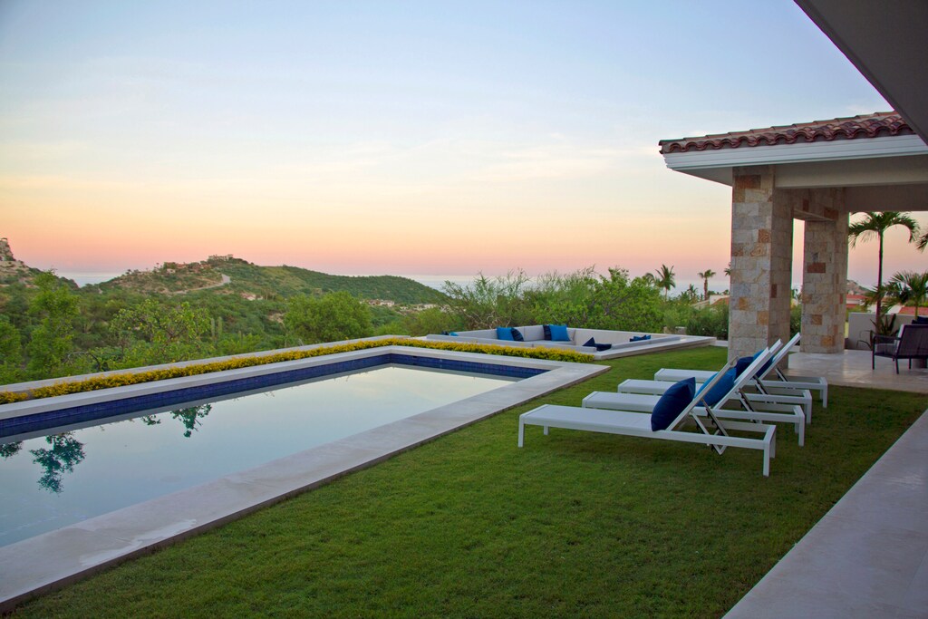Pool with ocean view during sunset