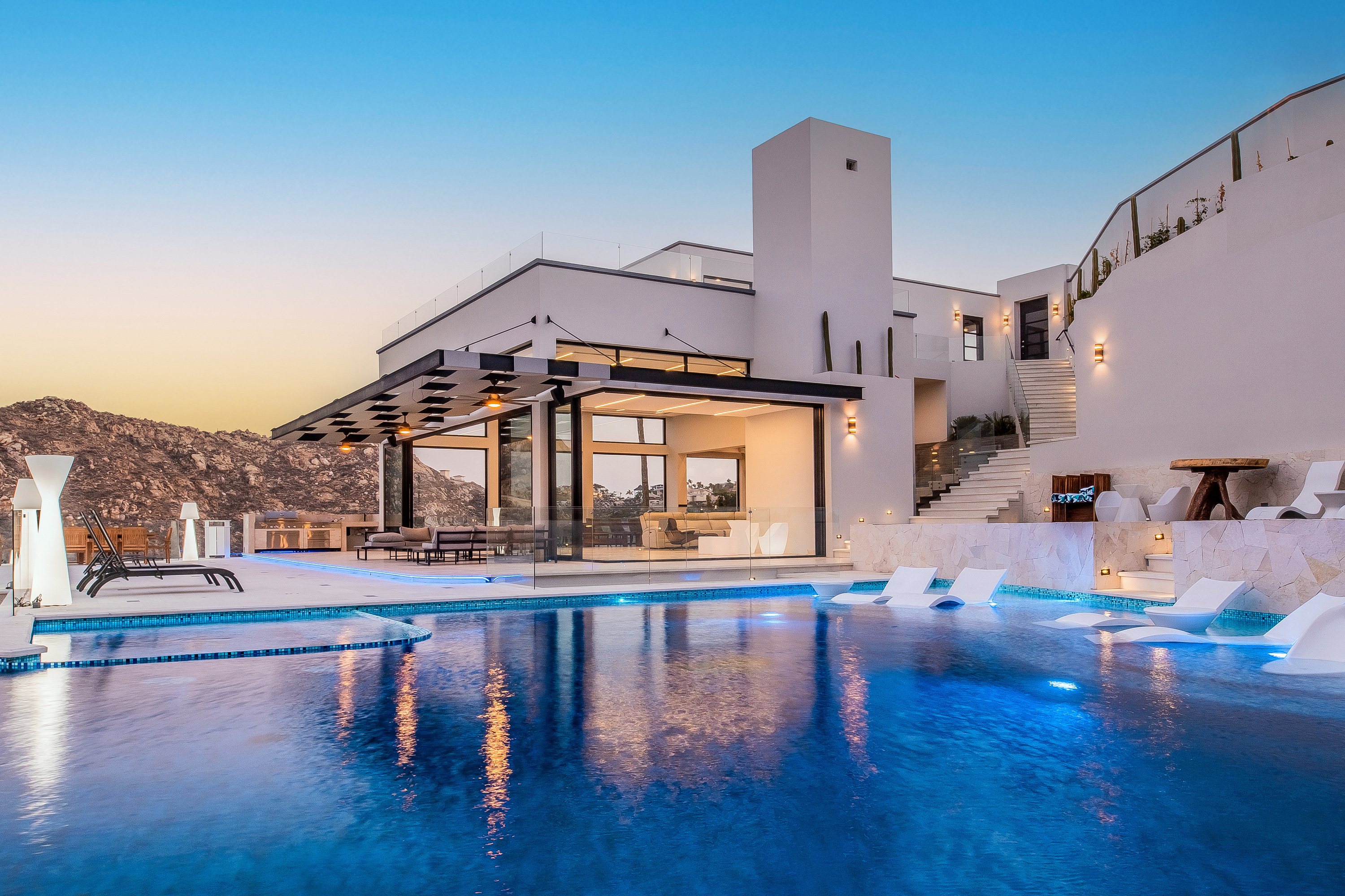 Poolside view of villa during sunset