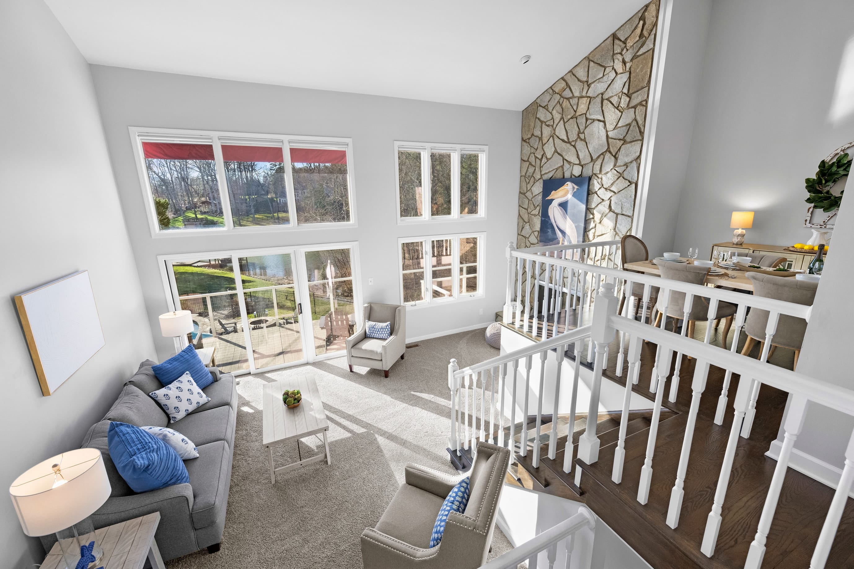 Main level living room (2) with comfortable seating overlooking Lake Norman. Slider access to the deck.