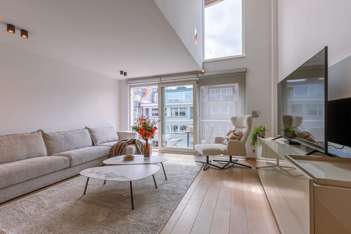 Spacious and modern living room with a large TV