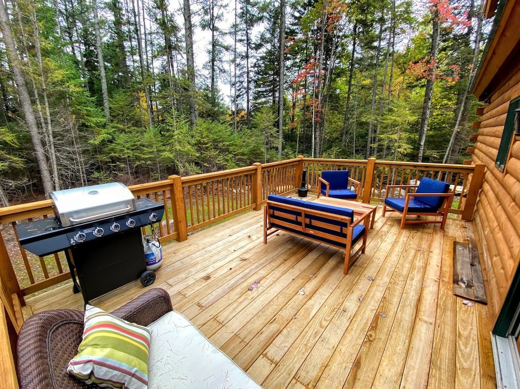 The deck overlooking the surrounding woods is a great spot to sit and enjoy the fresh air or use the grill.