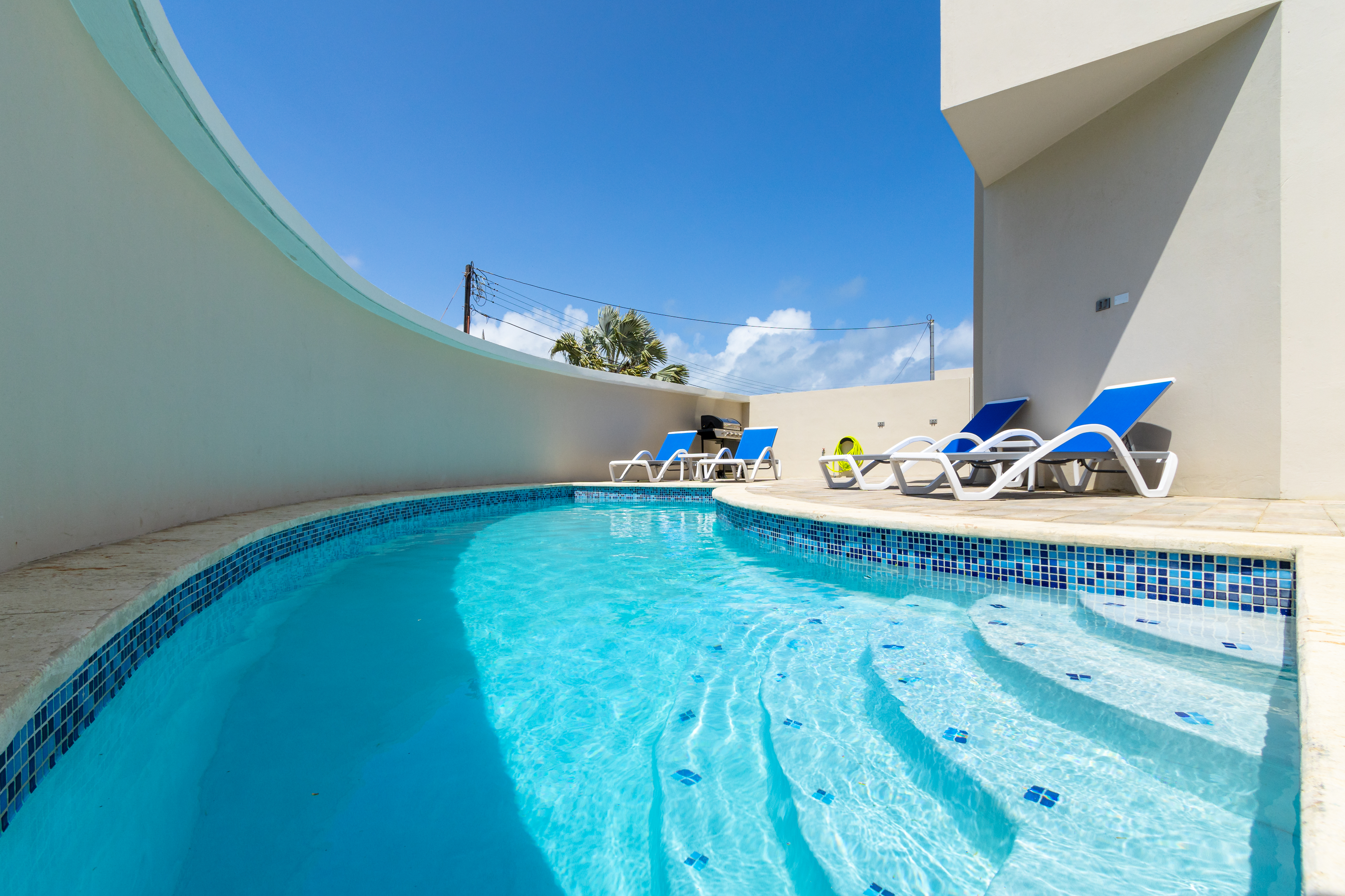 Lavish Private Pool Area of the Apartment in Noord Aruba - Enjoy leisurely moments in our inviting pool area - Comfortable Beach Chairs - Crystal Clear Water