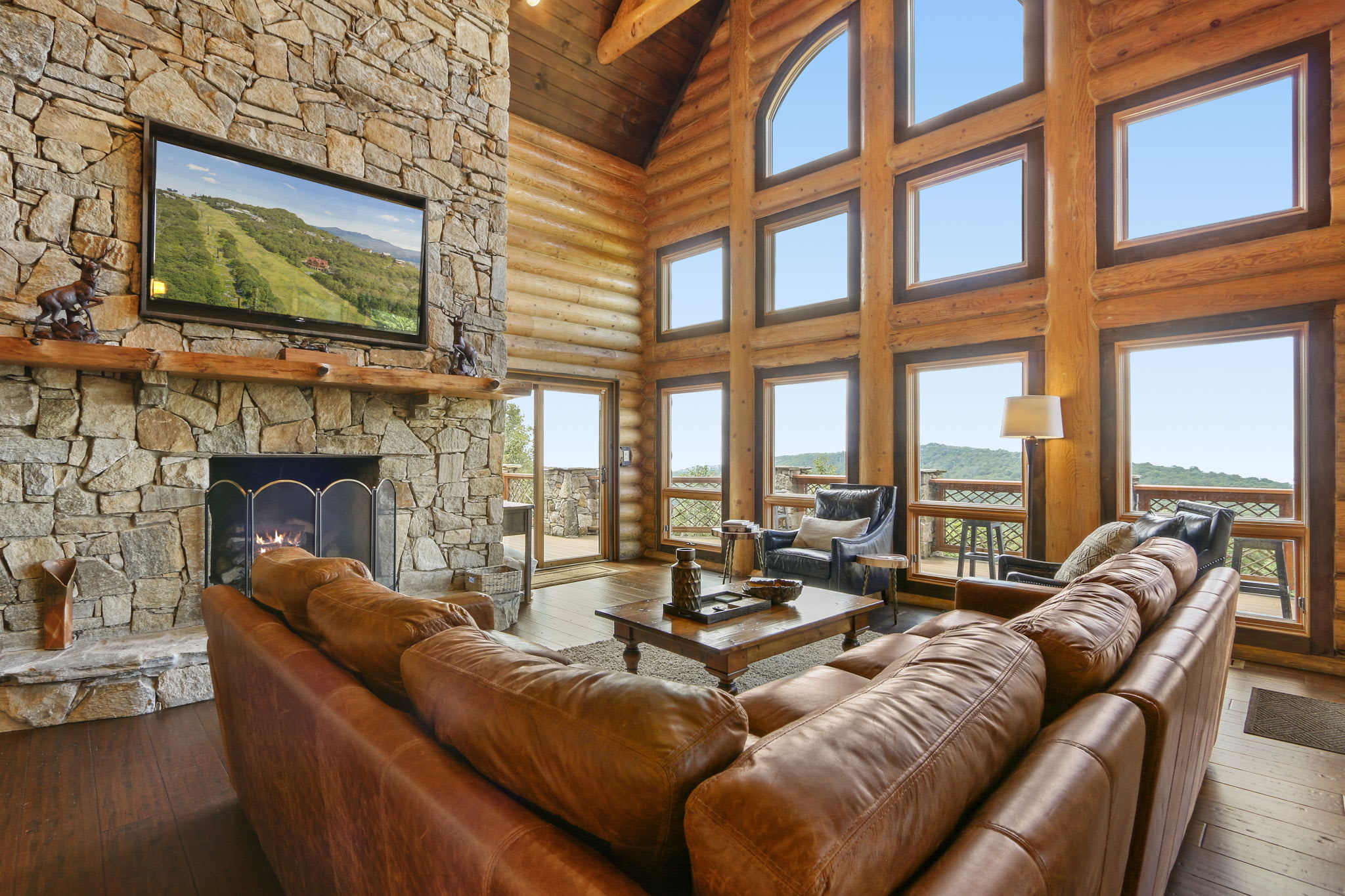 Cozy up on the plush couch or chairs by the fireplace for a perfect evening retreat in the rustic living room.