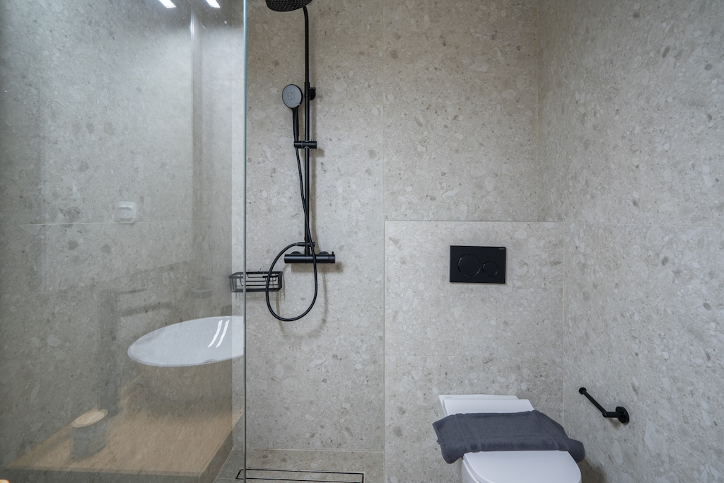 Unwind in your beautiful bathroom, where a refreshing rain shower experience awaits you.