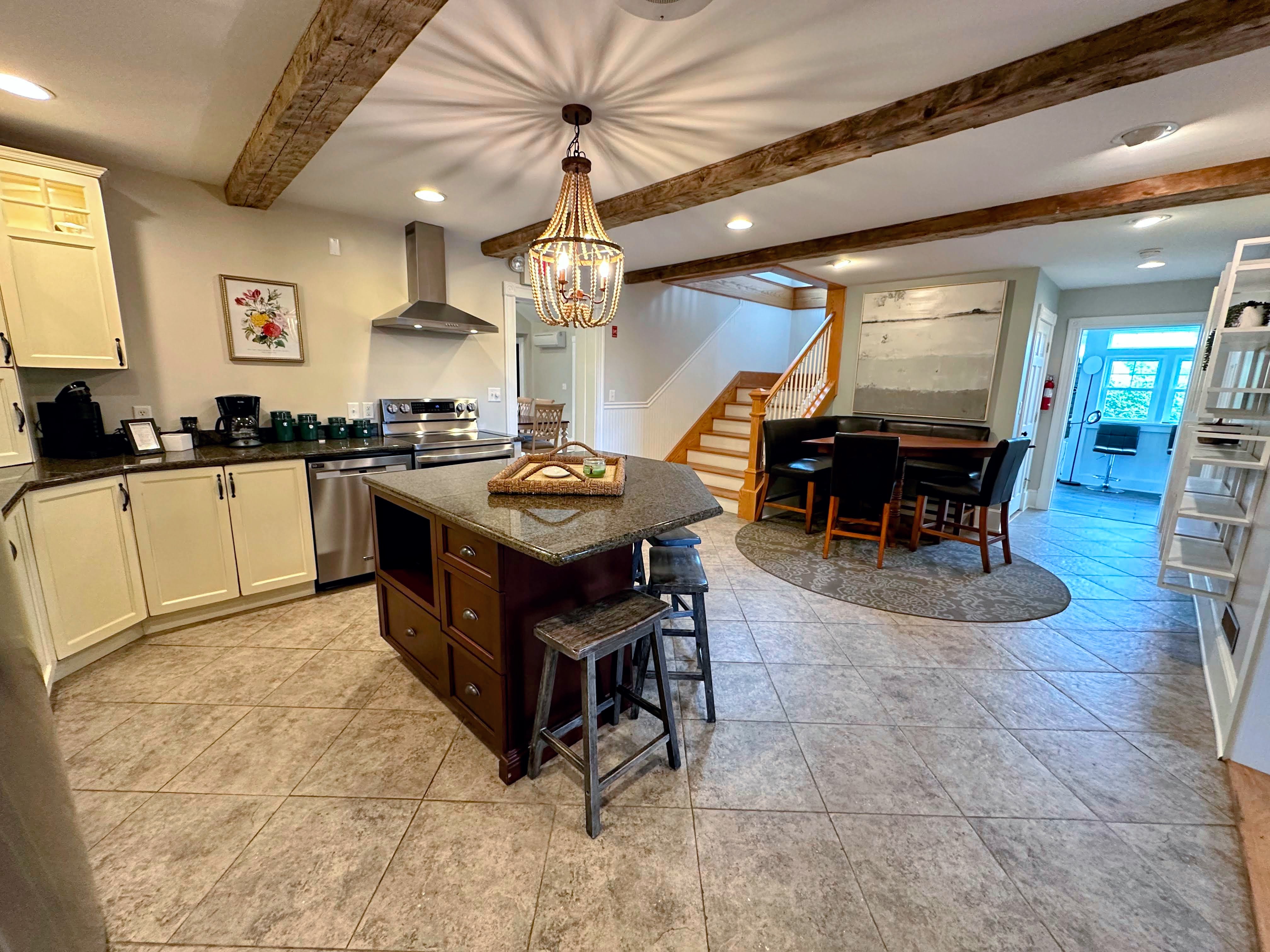 Full kitchen with breakfast bar and kitchen dining table