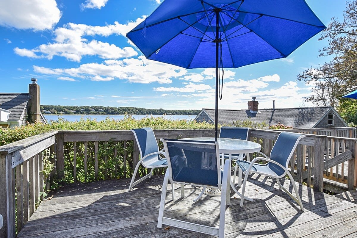 porch overlooking cove with table, chairs and umbrella