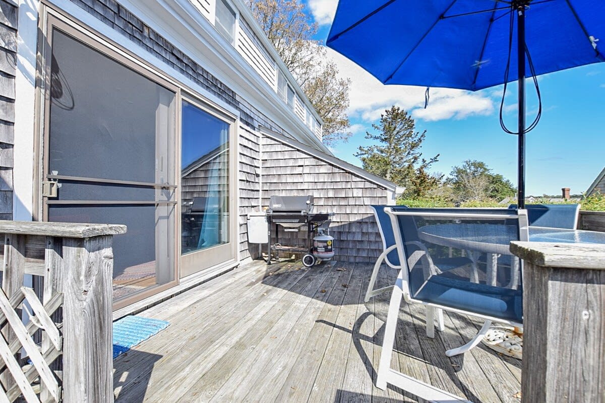 porch overlooking cove with table, chairs and umbrella