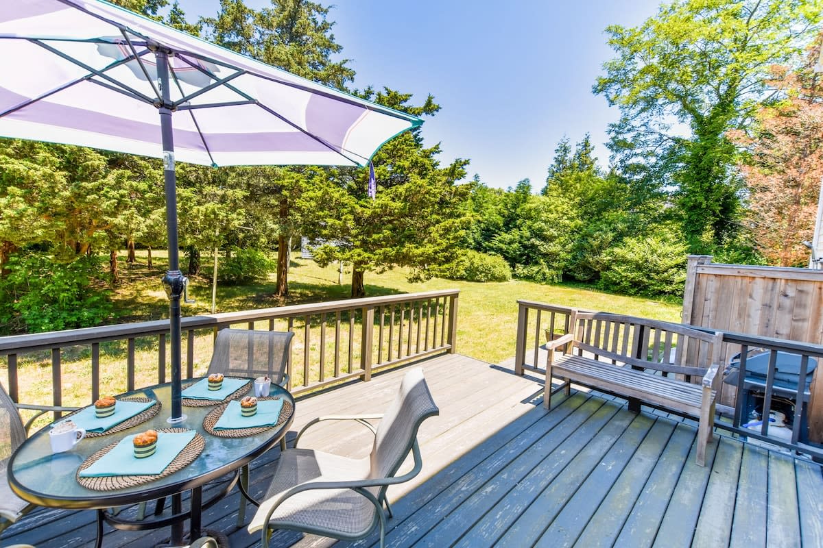 back deck with table, chairs and umbrella