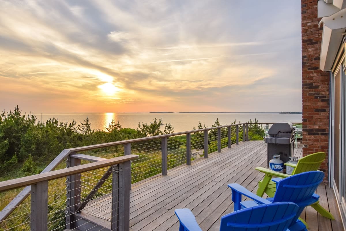 view of the sunset over the bay from back porch