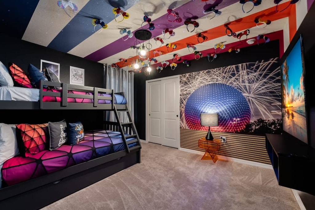 Experience a vibrant stay in this space-themed room with colorful decor and cozy bunk beds, perfect for a fun family getaway!