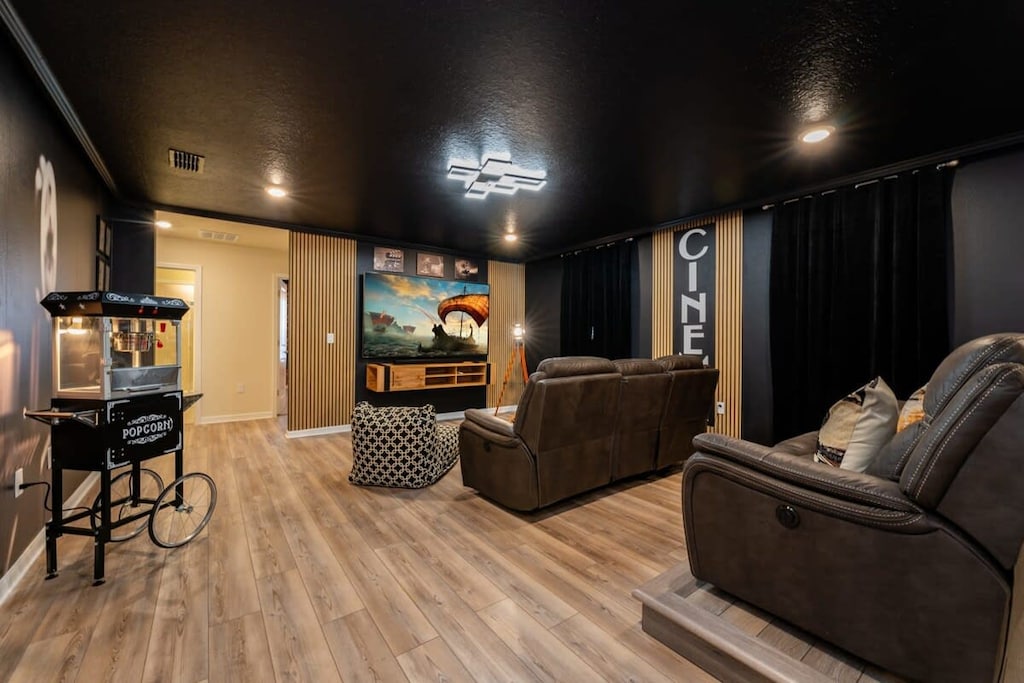 Experience movie nights like never before in this private home theater with plush seating and a vintage popcorn machine.