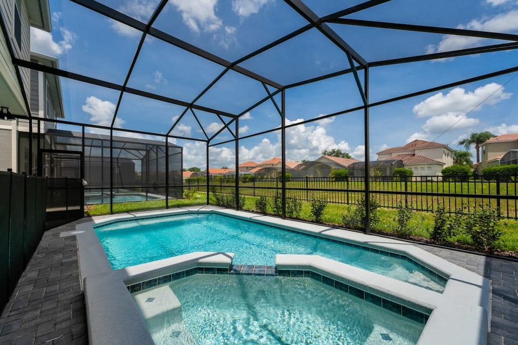 Enjoy a refreshing dip in your private screened pool and spa, surrounded by lush greenery and serene views.