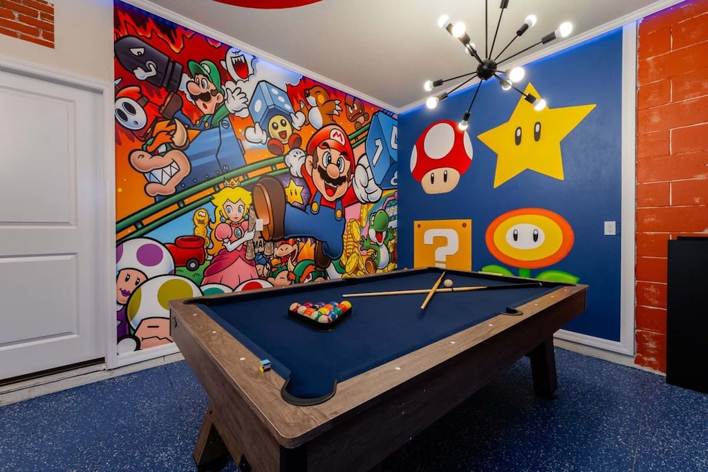 Dive into fun with a game-themed room featuring a vibrant mural and pool table for endless entertainment.