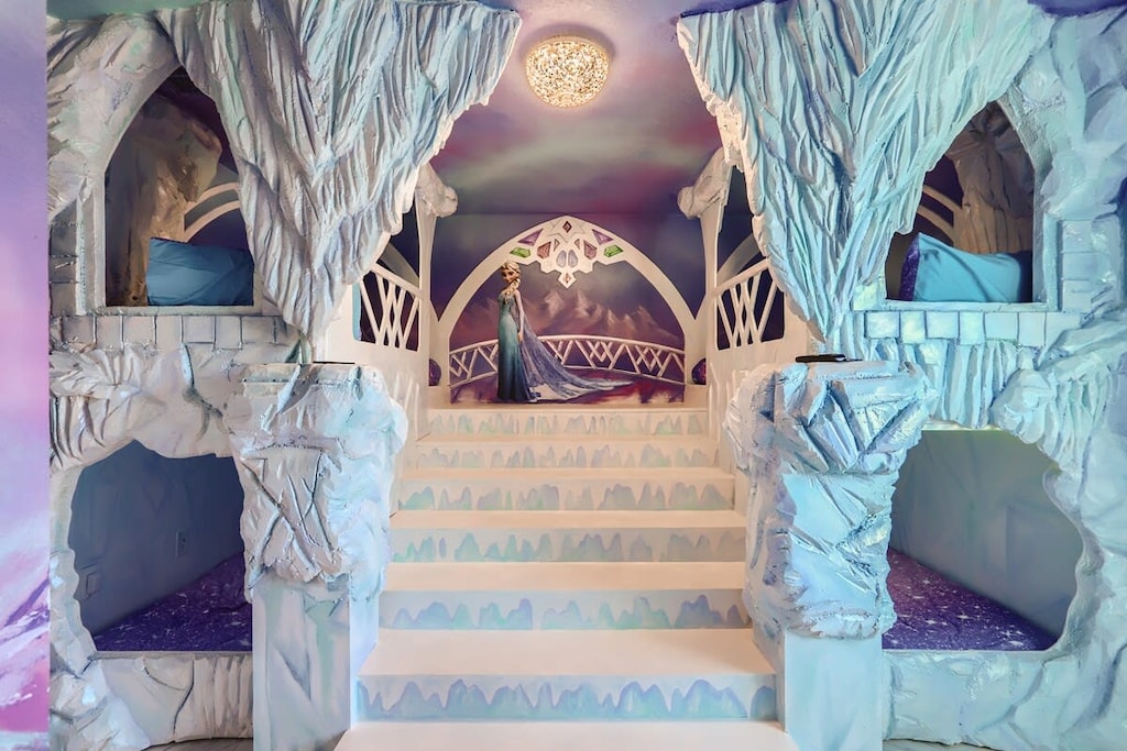Step into a magical ice kingdom with themed bunk beds and enchanting decor, perfect for a whimsical stay.