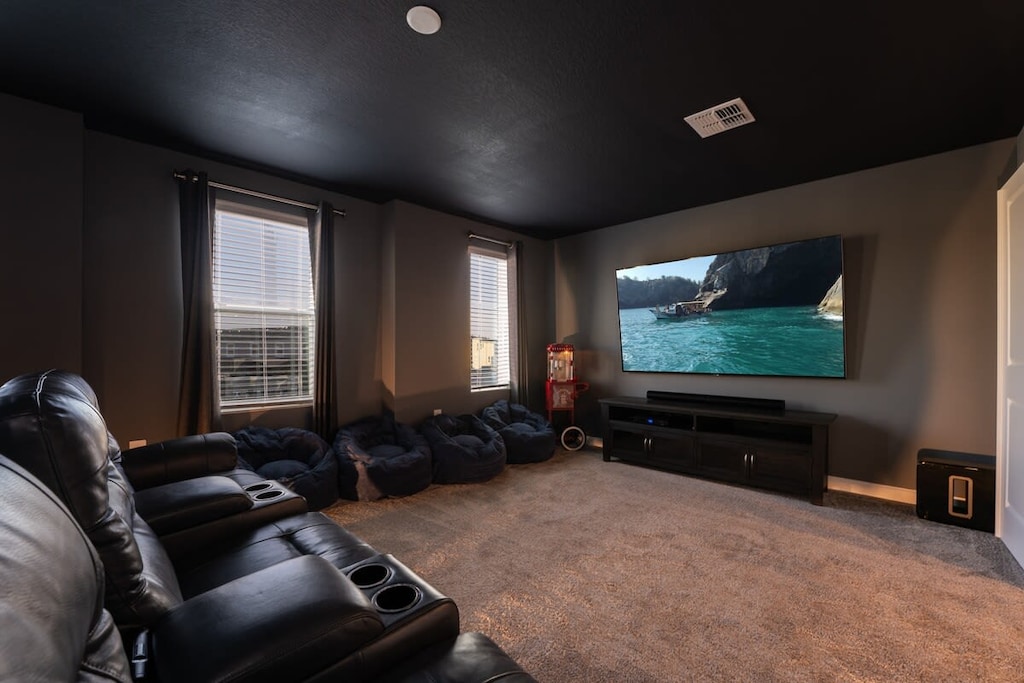 Experience cinematic comfort in this private home theater with plush seating and a large screen for ultimate relaxation.
