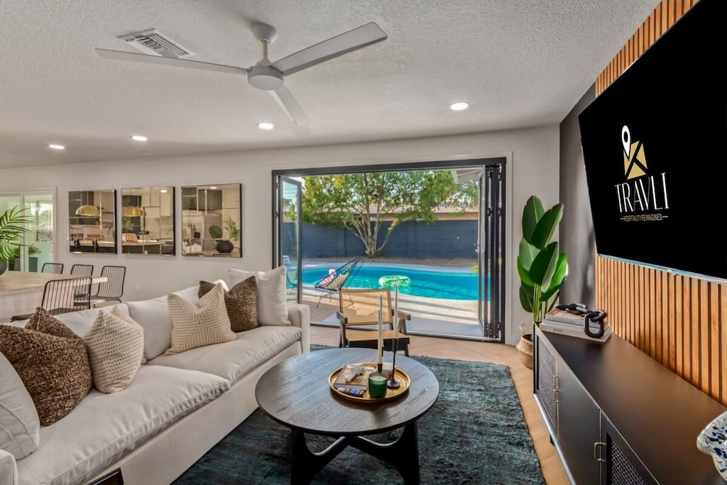 Cozy Living Room with large accordion doors to the pool deck