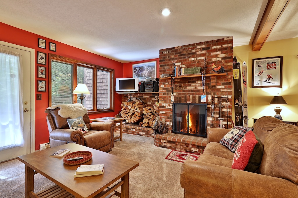 Relax next to the wood burning fireplace in the cozy living room