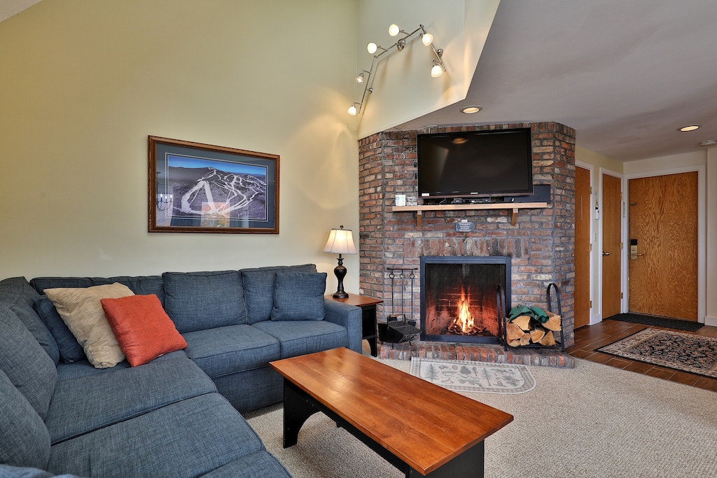 Cozy living room area and wood burning fireplace.