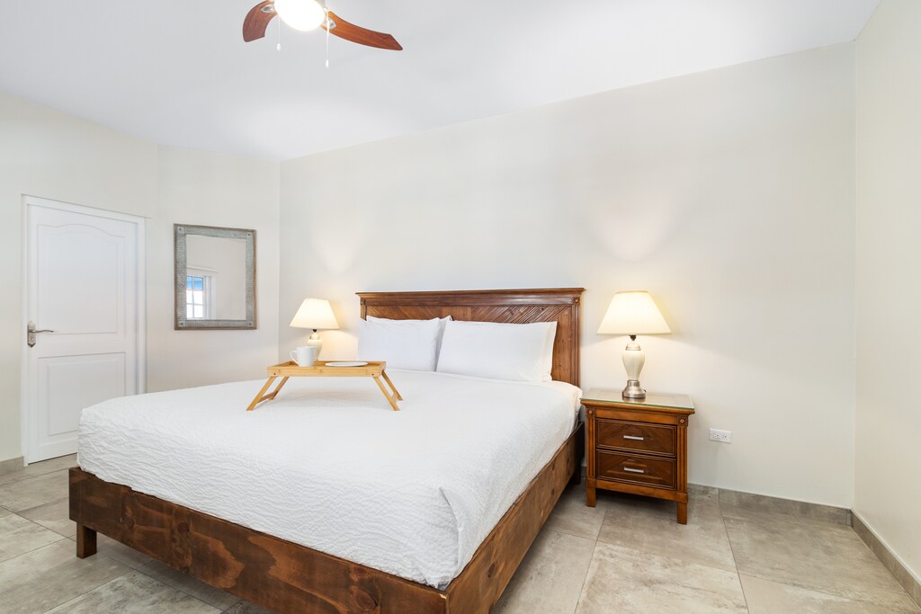 Unwind in style: the fourth bedroom offers the convenience of a king bed and ensuite bathroom, ensuring a peaceful retreat.