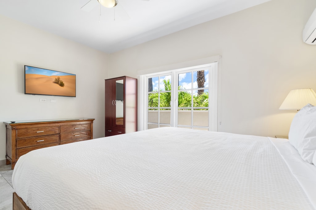 Bedroom 2 with a wall-mounted flat-screen Smart TV for your entertainment.