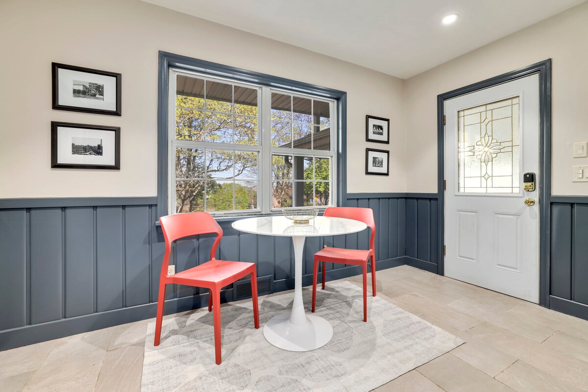 A two-top table sits to the right of the kitchen area, offering a comfortable place to enjoy breakfast or a cup of coffee.
